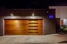 two garage doors with lights on at night