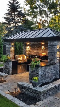 an outdoor kitchen with grill and seating area