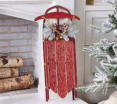 a wooden sled with decorations on it next to a fireplace