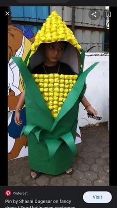 a young boy dressed up as a corn on the cob