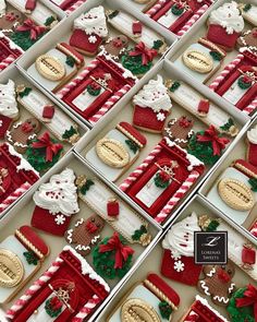 many decorated cookies in boxes on display for sale at a christmas party or holiday event