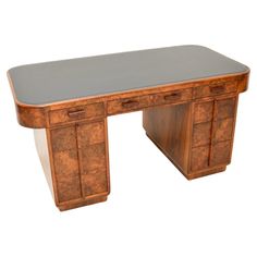 an antique desk with two drawers on one side and a grey table top on the other