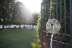 a wedding wreath is placed on the gate