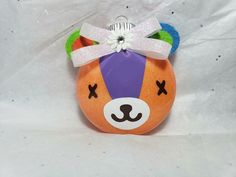 an ornament shaped like a bear with a bow on it's head