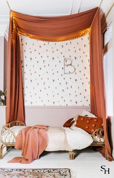 a canopy bed with pillows and blankets on it