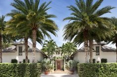 a house with palm trees in front of it