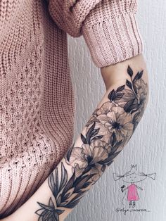 a woman's arm with flowers on it