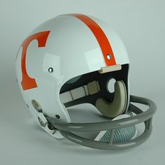 an orange and white football helmet on a gray background