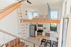 an open loft with stairs leading up to the kitchen