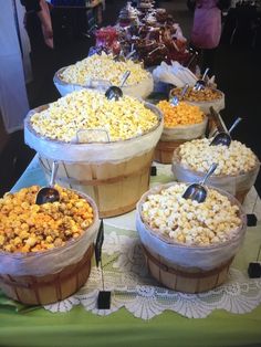 several baskets filled with popcorn on top of a table