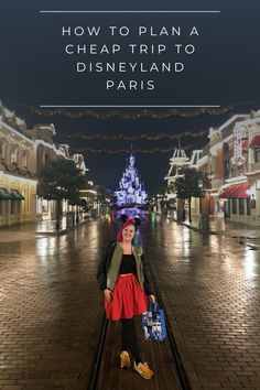 a woman walking down a street at night with the words how to plan a cheap trip to disneyland paris