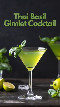 two glasses filled with green cocktail and garnished with basil