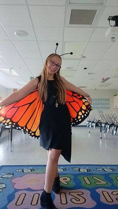 a girl in a black dress and butterfly wings