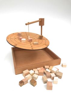 a wooden board game with blocks and a hammer