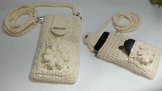 two crocheted purses sitting next to each other on a white counter top