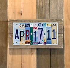 a license plate is hanging on a wooden wall