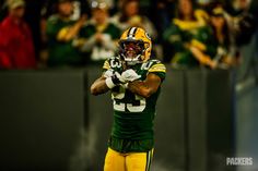 a green bay packers football player holding his hands together