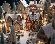 a christmas village with lit up houses and trees