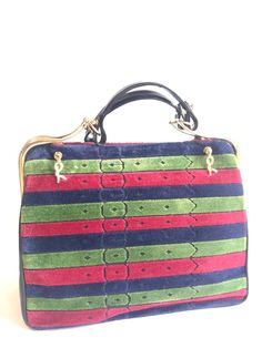 "For all Roberta vintage lovers, this handbag is the one for you! 70s-80s, one-of-a-kind beautiful purse by Roberta di Camerino.... Featuring its iconic tricolor in red, navy, and green stripe design on both sides and golden \"R\" dangling charms. Normal sign of use and age with some scuffs and scratches. The golden brass shows some tarnishing partially. Some scratches and scuffs are seen in the interior linings. No wears are seen on the handles and corners. Overall, it is still in a good vintag Vintage Green Satchel For Formal Occasions, Green Vintage Top Handle Satchel, Vintage Green Formal Satchel, Vintage Green Satchel For Shopping, Retro Green Evening Bags, Green Retro Formal Bags, Multicolor Rectangular Satchel For Formal Occasions, Formal Multicolor Rectangular Satchel, Retro Multicolor Shoulder Bag For Evening