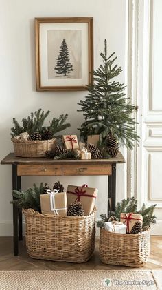 christmas trees and presents in wicker baskets on a table with a pine tree behind them