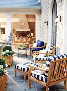 an outdoor patio with chairs and potted plants