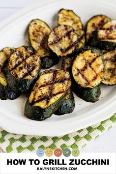 Pinterest image showing slices of grilled zucchini on white oval ceramic platter sitting on green and white checkered napkin. How To Grill Zucchini, Grill Zucchini, Marinated Zucchini, Gluten Free Grilling, Vegan Zucchini Recipes, Grilled Zucchini Recipes, Zucchini Side Dishes, How To Cook Zucchini, Zucchini Salad