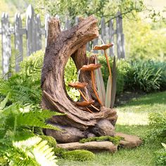 a wooden sculpture in the middle of a garden