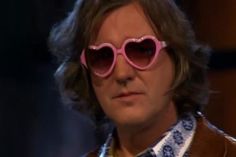 a man wearing pink heart shaped sunglasses on his face