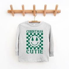 Looking for a cute long sleeve tee for your kids? We have the perfect Christmas Cutie Checkered graphic tee addition to their closet! Also available in toddler tees. Toddler Christmas Shirt, Christmas Shirts For Kids, Diy Shirts, Kids Clothes Boys, Toddler Boy Outfits, Long Sleeve Jersey, Top Graphic Tees, Toddler Tees, Diy Shirt