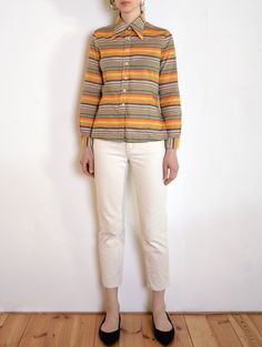 Cool vintage blouse made of lightweight cotton fabric with print of stripes of different widths in iconic 1970s sunset tones: orange and yellow with a hint of gray, black and white. Pointed collar, white pearly buttons. Long sleeves, with buttoned cuffs. Era: 70's, made in Germany Fabric: 100% cotton   Condition: very good Estimated size: S / M (please, check the measurements) Measurements (measured flat, need to be doubled to get the circumference): Chest: 52 cm / 20,4 inches Length: 65 cm / 25 Star Clothing, Jaune Orange, Cool Vintage, Lovely Dresses, Blouse Vintage, Cotton Top, Striped Blouse, Orange Yellow, Cotton Tops