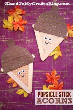 some paper crafts with leaves and acorns on them