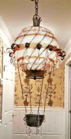 a chandelier hanging from the ceiling in a hallway with wallpapered walls