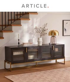 an image of a living room setting with article on the sideboard and stairs