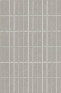 a white tile wall with grey squares on it