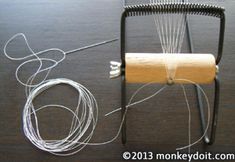 a roll of toilet paper sitting on top of a wooden table next to a wire holder