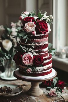 a three layer red velvet cake with flowers on top