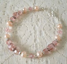 "This beautiful bracelet has freshwater pearls, pink Swarovski glass beads, sterling silver plated bead caps, sterling silver plated accent beads and seed beads. A lovely design for a wedding or special occasion. 7\" long can be adjusted to 8\". Sterling silver plated lobster clasp." Pink Pearl Bracelet For Wedding, Delicate Pink Bracelets For Wedding, Delicate Pink Bracelet For Wedding, Delicate Handmade Pink Pearl Bracelet, Handmade Pink Crystal Elegant Bracelet, Delicate Pink Bracelets For Jewelry Making, Handmade Elegant Pink Crystal Bracelet, Feminine Adjustable Beaded Bracelets For Wedding, Elegant Handmade Pink Crystal Bracelet