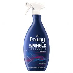 a bottle of downy wrinkle releaseer on a white background with a spray