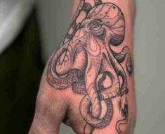 a hand with an octopus tattoo on it