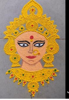 the face of a woman is made out of yellow and green thread with beads on it