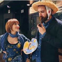 a man in a straw hat eating something next to a woman wearing a blue dress