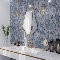 a bathroom with marble counter tops and gold accents on the wall, along with two sinks