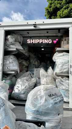 the back of a moving truck filled with lots of bags and supplies for shipping to customers