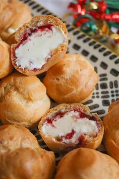 several rolls with cream cheese on them are sitting on a plate next to christmas decorations