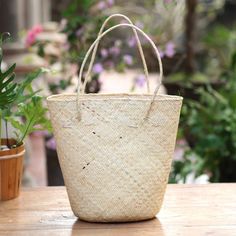 Putu Suryawan creates serene textures in natural ivory rattan. This roomy open-top tote is woven by hand in diagonals and the result is extraordinary. With its trendy organic style it goes with you to the beach to the market or for a walk in the park. Take it along. Natural Straw Bag Fair Trade, Natural Straw Fair Trade Bag, Beige Fair Trade Straw Bag, Eco-friendly Natural Straw Market Bag, Natural Rattan Straw Bag For Market, Eco-friendly Fair Trade Beige Straw Bag, Eco-friendly Natural Color Straw Bag, Eco-friendly Palm Leaf Straw Bag With Open Weave, Eco-friendly Natural Straw Bag With Open Weave