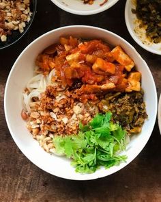 several bowls filled with different types of food