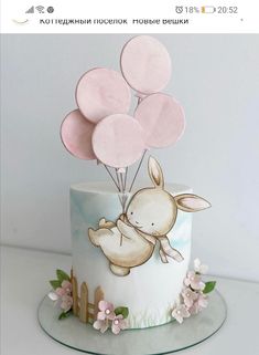 a cake decorated with balloons and an animal