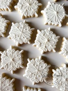 snowflake cookies are arranged in rows on a white surface with text overlay