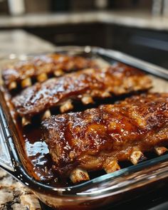 some ribs are in a glass dish on the counter