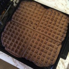 a waffle iron sitting on top of a counter next to an electric stove burner